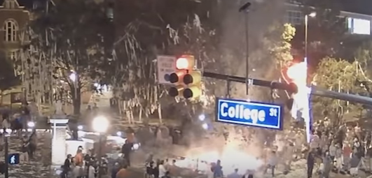 Screen capture from security video footage showing someone setting fire to toilet paper hanging from Oak Tree at Toomer's Corner, Auburn, Alabama. Security video footage published on YouTube by al.com Blog post explaining difference between HD, IP video and low resolution video security cameras. Vulcan Security Systems, Birmingham, AL www.vulcansecuritysystems.com