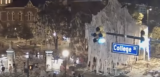 Screen capture from security video footage showing someone setting fire to toilet paper hanging from Oak Tree at Toomer's Corner, Auburn, Alabama. The fire spread rapidly milliseconds later. Security video footage published on YouTube by al.com Blog post explaining difference between HD, IP video and low resolution video security cameras. Vulcan Security Systems, Birmingham, AL www.vulcansecuritysystems.com