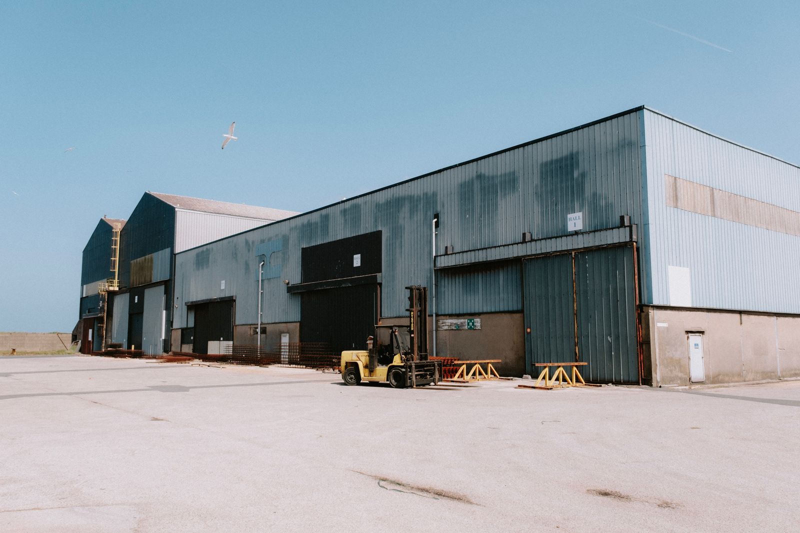 Forklift moving freight outside a warehouse loading dock