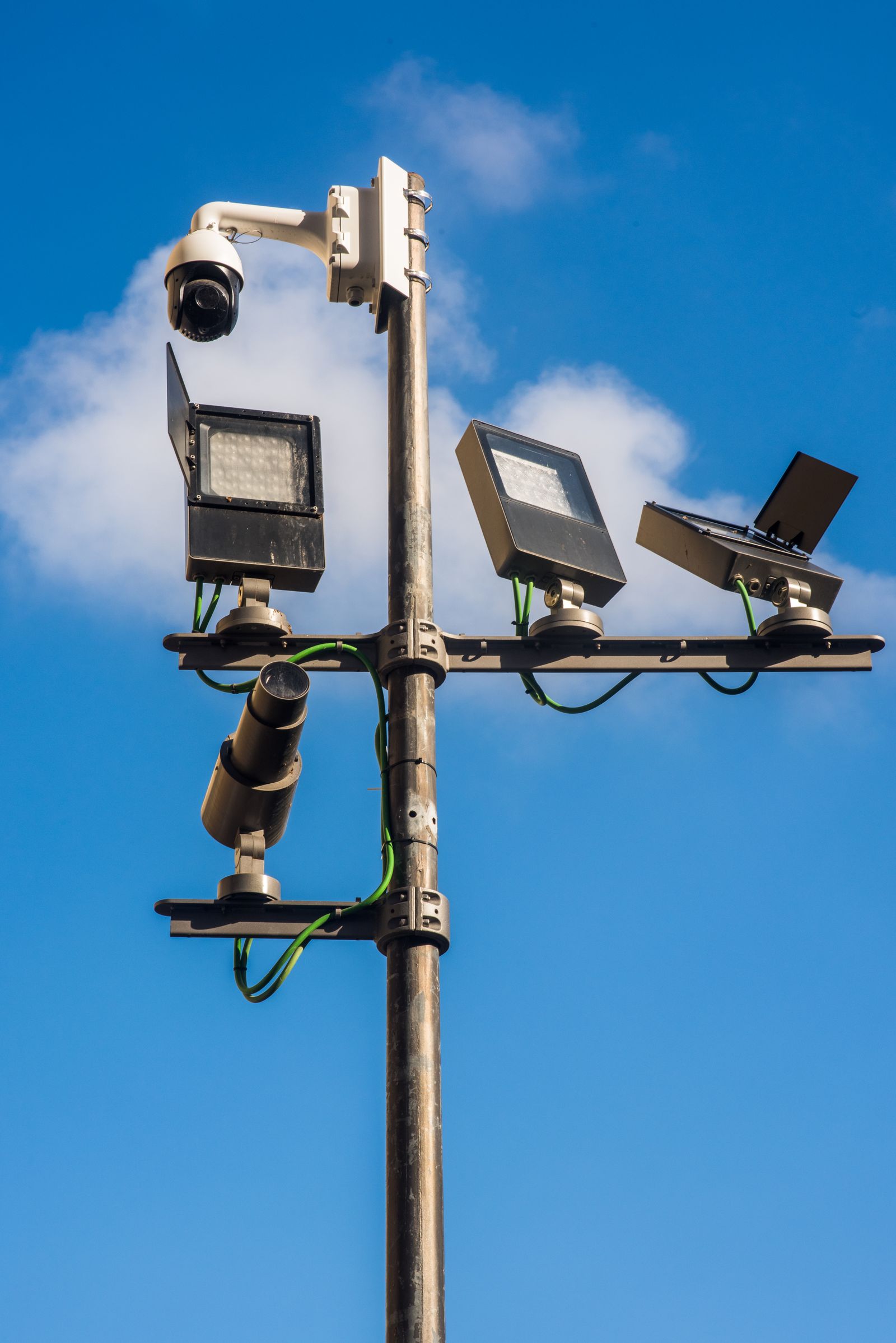 Security cameras mounted on a pole overlooking a distribution center yard